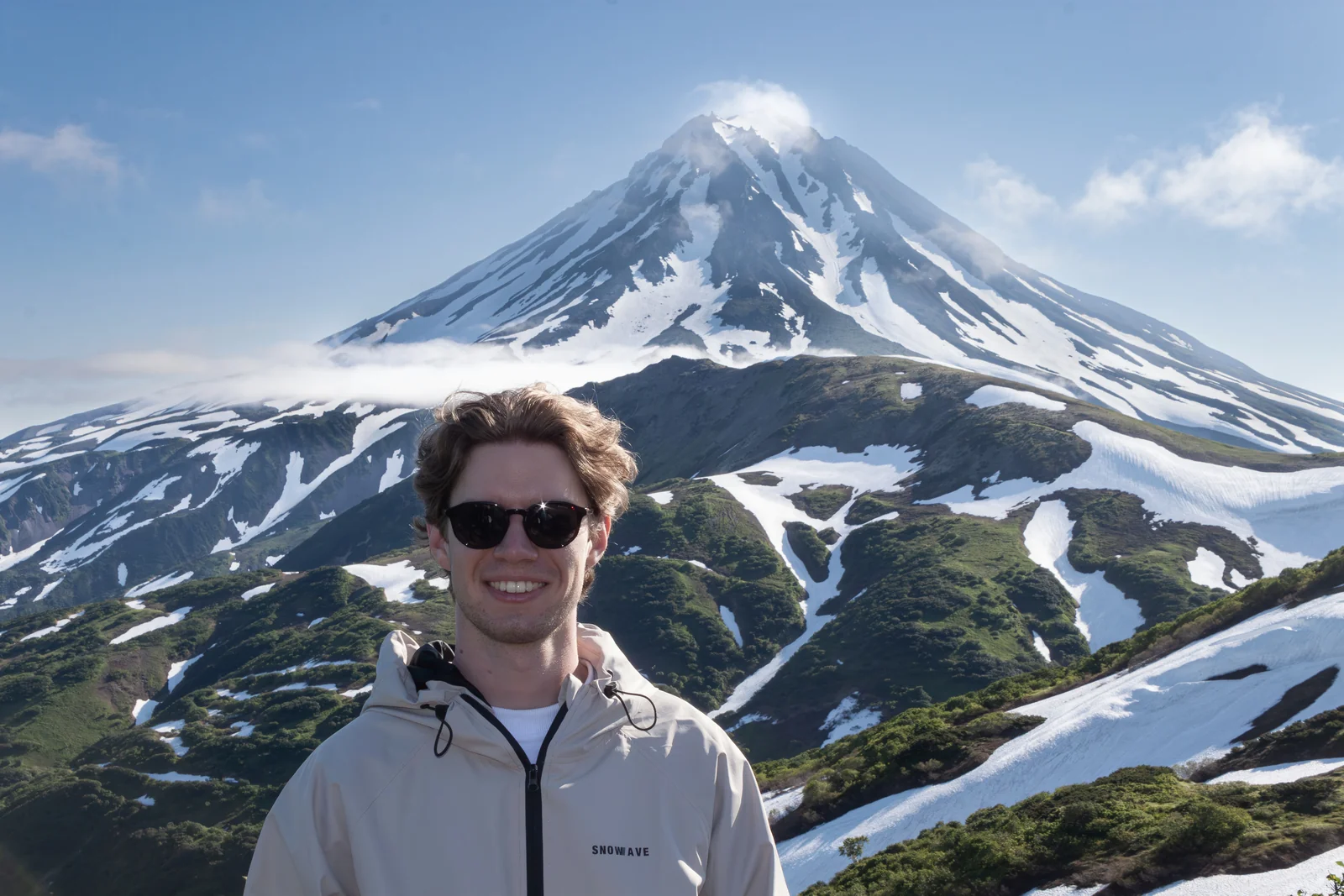 Danila Karnatsevich in front of a snow-covered volcano